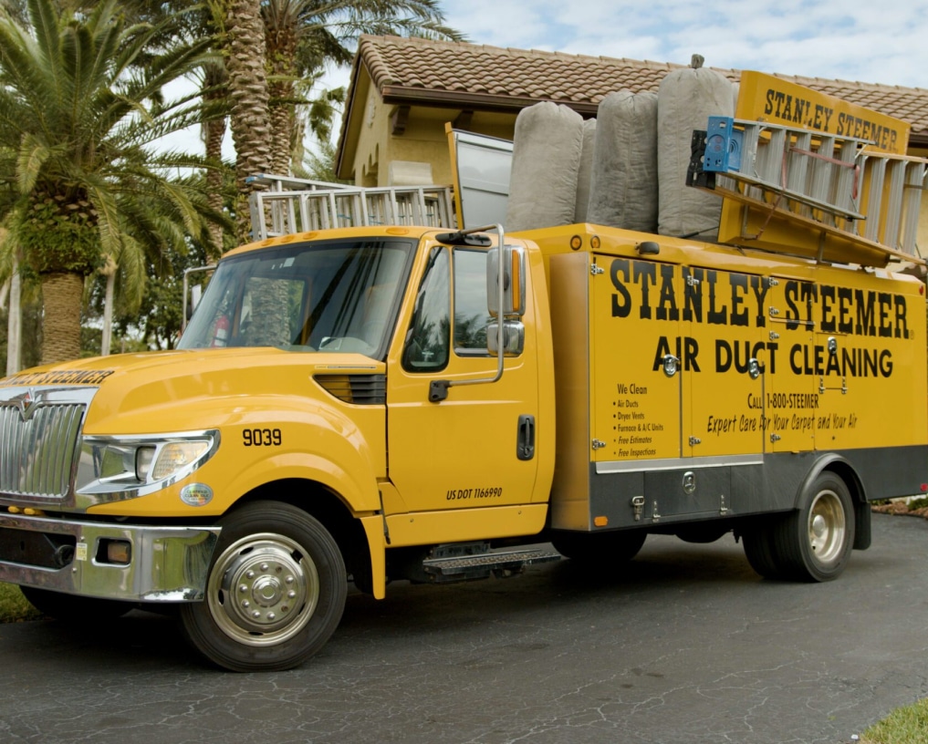 Stanley Steemer air duct cleaning truck parked outside a home, equipped with professional HVAC cleaning tools and equipment.